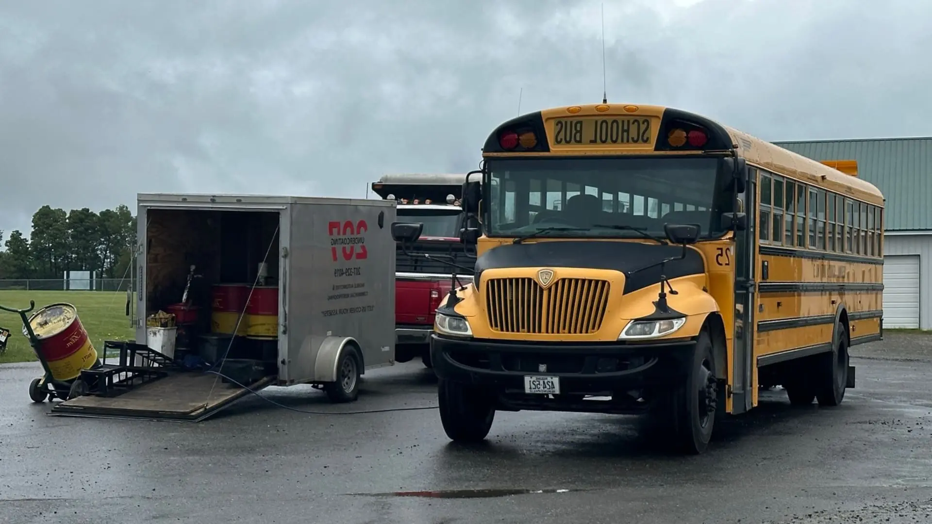 School bus receiving rust proofing undercoating services